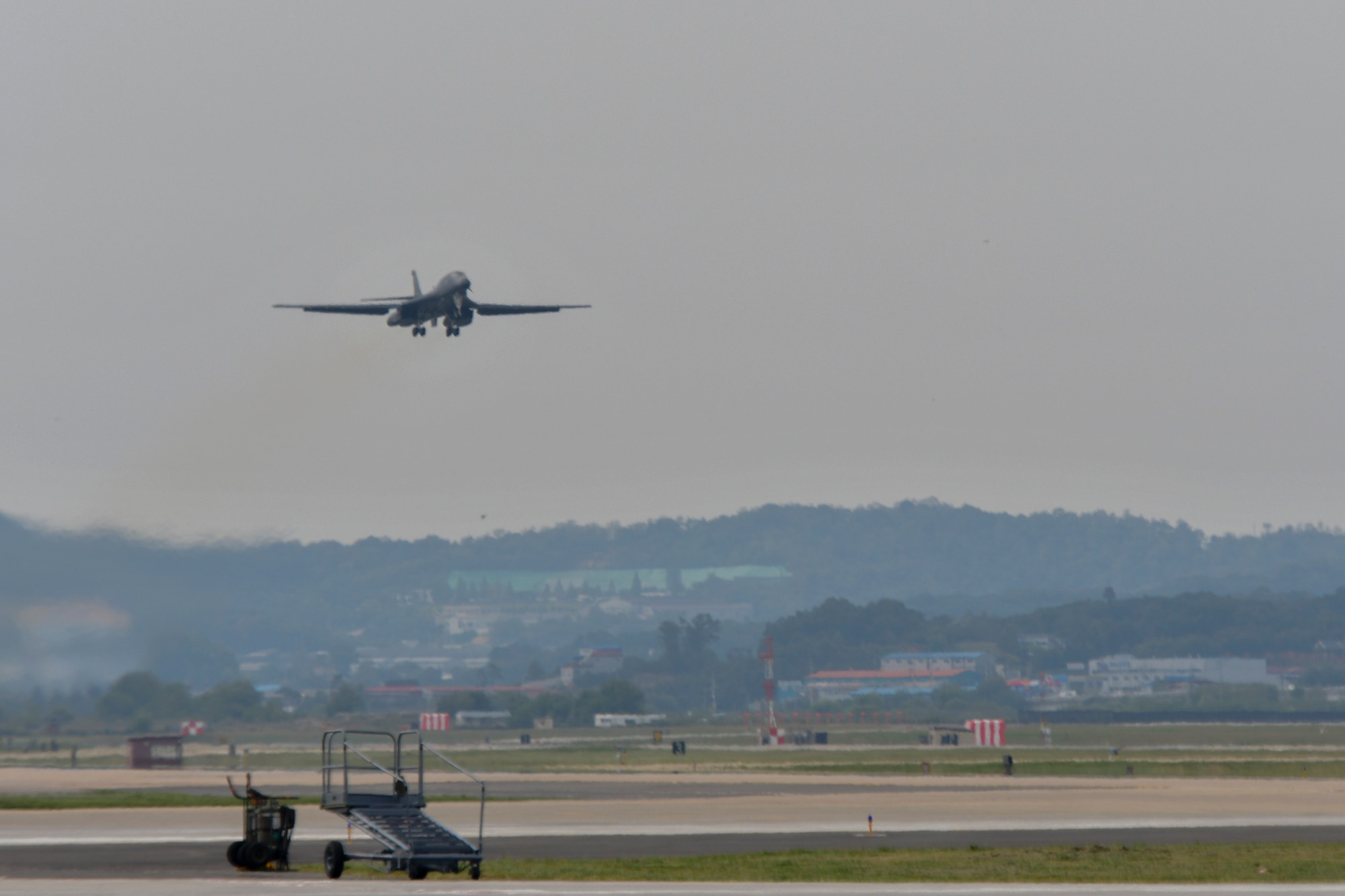 A U.S. Air Force B-1B Lancer deployed from Andersen Air Base, Guam, performs a flyover at Osan Air Base, Republic of Korea, Sept. 21, 2016. The Lancer had just conducted the closest flight to the North Korean border in its operational history, as well as landing on the Korean peninsula for the first time in 20 years. The B-1 is the backbone of the U.S. long-range bomber mission and is capable of carrying the largest payload of both guided and unguided weapons in the Air Force inventory. (U.S. Air Force photo by Senior Airman Victor J. Caputo)