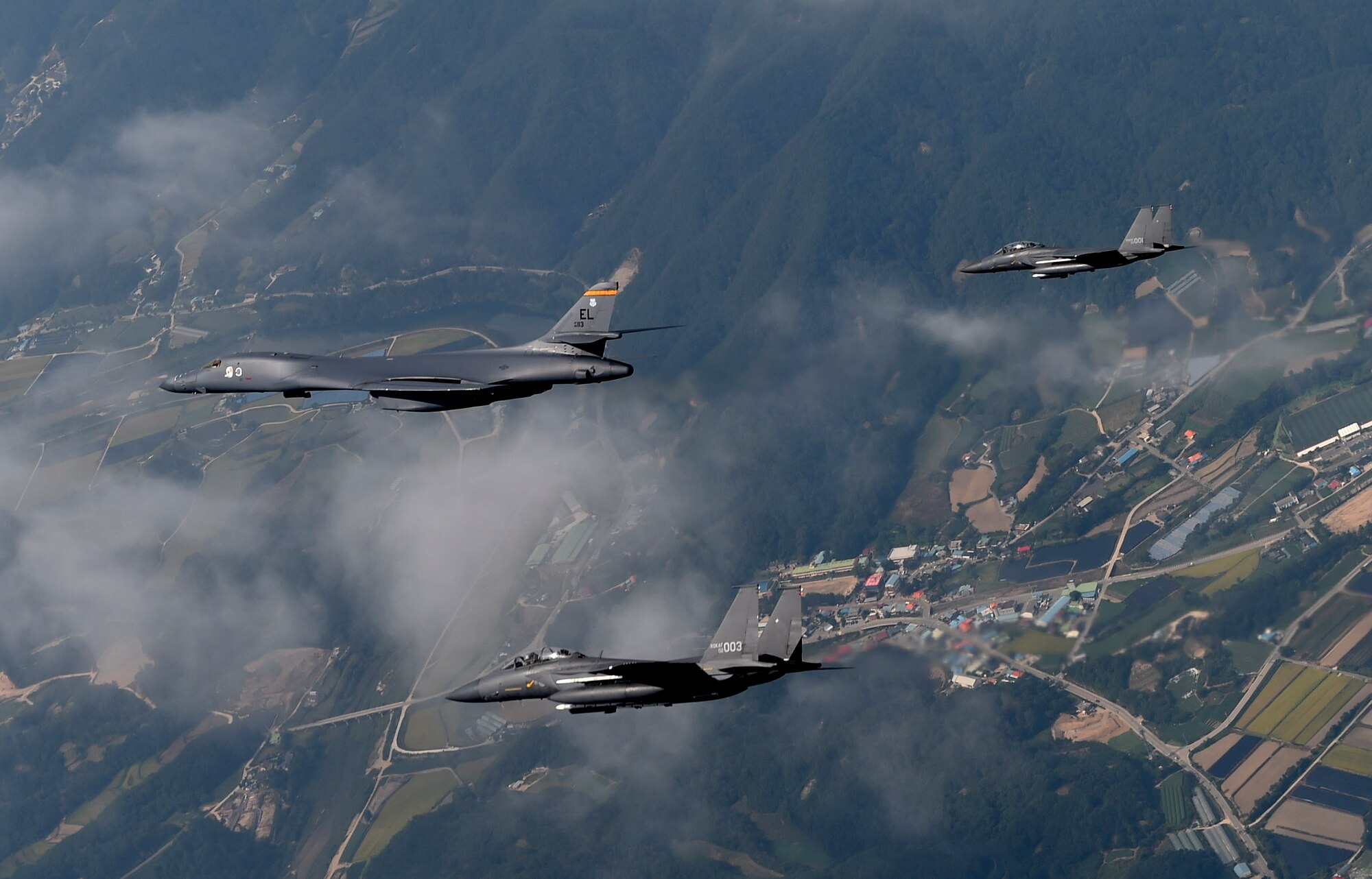 A U.S. Air Force B-1B Lancer deployed to Andersen Air Base, Guam, is flanked by two F-15K Slam Eagles assigned to Daegu Air Base, Republic of Korea, during flight over ROK skies Sept. 21, 2016. The flight was the closest a B-1 has ever flown to the border between the ROK and North Korea. The B-1 is the backbone of the U.S. long-range bomber mission and is capable of carrying the largest payload of both guided and unguided weapons in the Air Force inventory. (Republic of Korea air force photo by Chief Master Sgt. Kim, Kyeong Ryul)