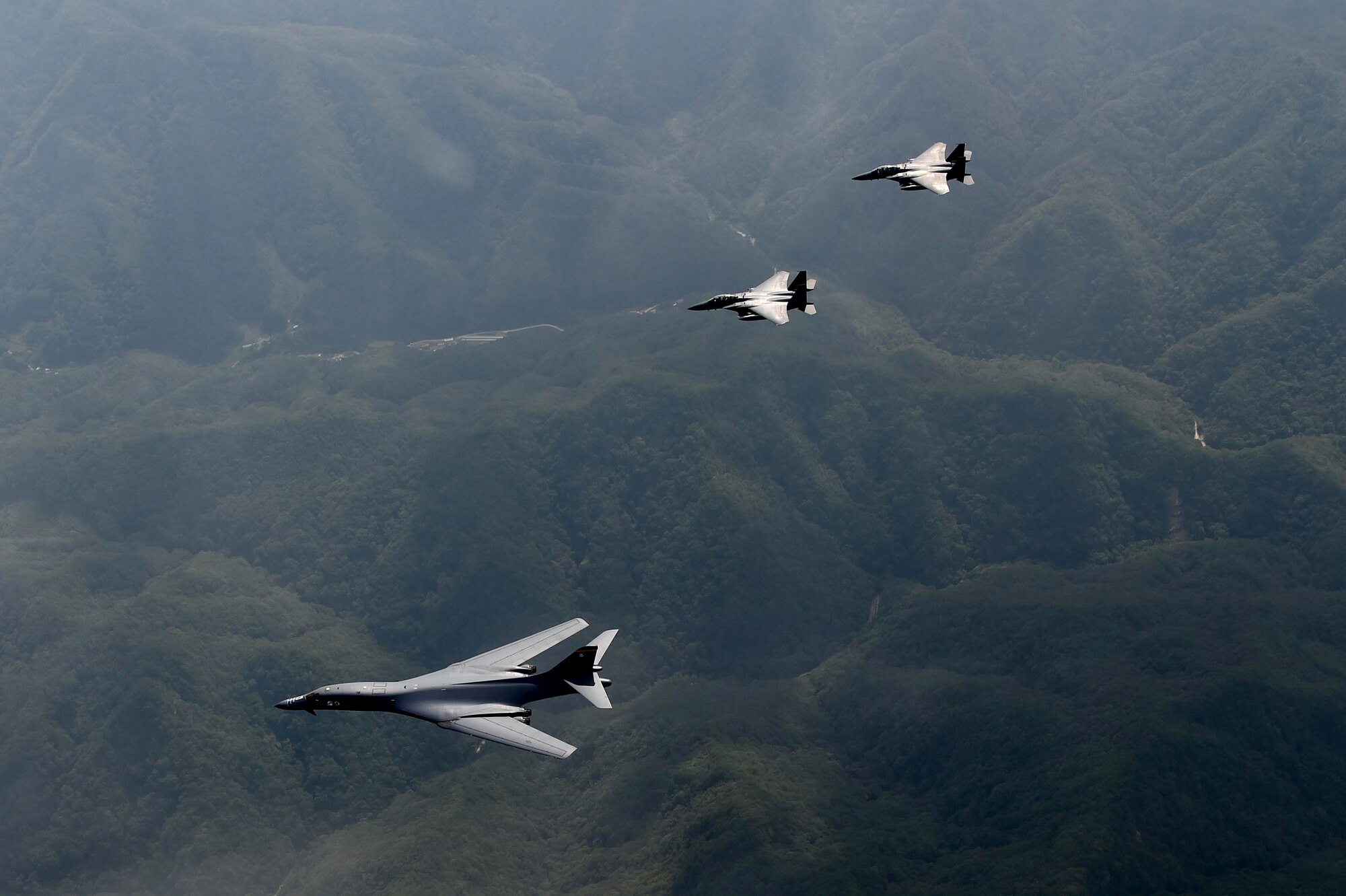 Two U.S. Air Force B-1B Lancers deployed to Andersen Air Base, Guam, and two F-15K Slam Eagles assigned to Daegu Air Base, Republic of Korea, fly over ROK skies Sept. 21, 2016. The flight was the closest a B-1 has ever flown to the border between the ROK and North Korea. The B-1 is the backbone of the U.S. long-range bomber mission and is capable of carrying the largest payload of both guided and unguided weapons in the Air Force inventory. (Republic of Korea air force photo by Chief Master Sgt. Kim, Kyeong Ryul)