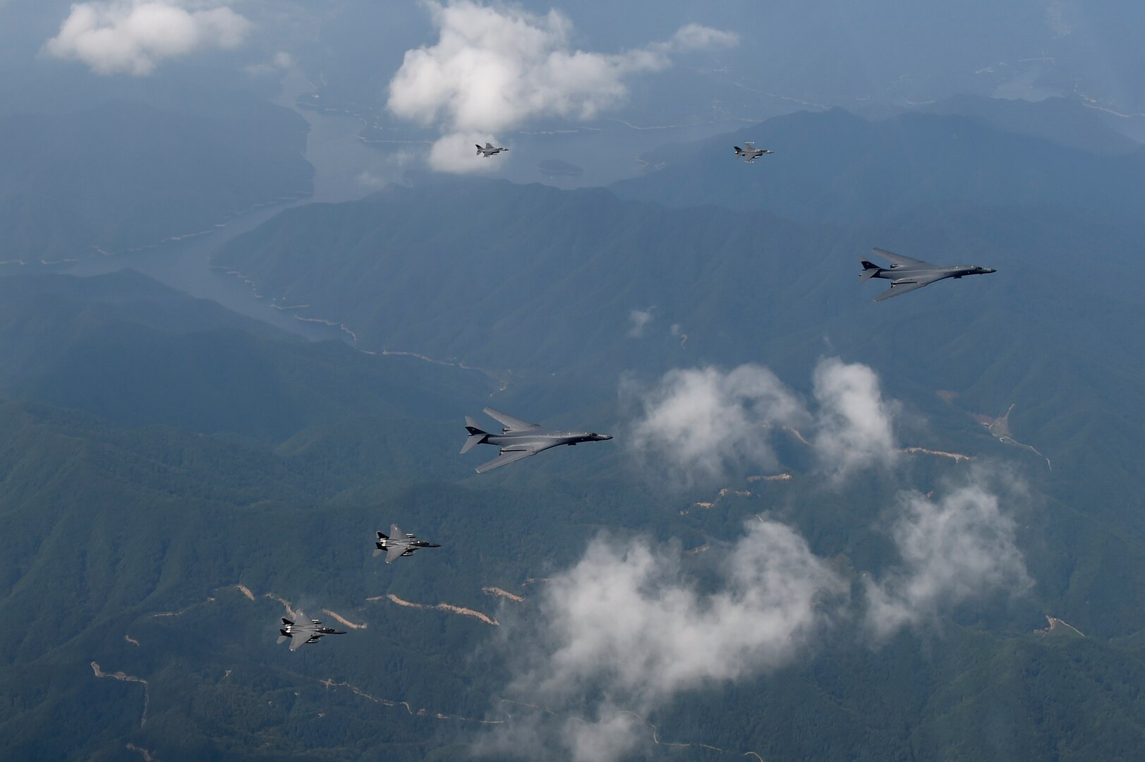 A formation of two B-1B Lancers deployed to Andersen Air Base, Guam, and four F-15K Slam Eagles assigned to Daegu Air Base, Republic of Korea, fly over ROK skies Sept. 21, 2016. The flight was the closest a B-1 has ever flown to the border between the ROK and North Korea. The B-1 is the backbone of the U.S. long-range bomber mission and is capable of carrying the largest payload of both guided and unguided weapons in the Air Force inventory. (Republic of Korea air force photo by Chief Master Sgt. Kim, Kyeong Ryul)