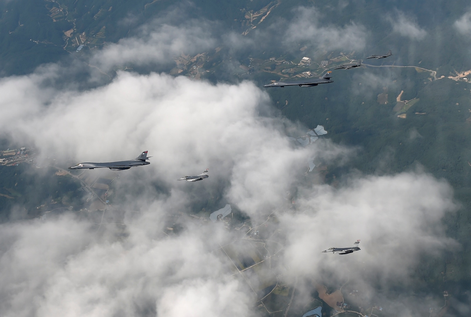 A formation of two B-1B Lancers deployed to Andersen Air Base, Guam, and four F-15K Slam Eagles assigned to Daegu Air Base, Republic of Korea, fly over ROK skies Sept. 21, 2016. The flight was the closest a B-1 has ever flown to the border between the ROK and North Korea. The B-1 is the backbone of the U.S. long-range bomber mission and is capable of carrying the largest payload of both guided and unguided weapons in the Air Force inventory. (Republic of Korea air force photo by Chief Master Sgt. Kim, Kyeong Ryul)