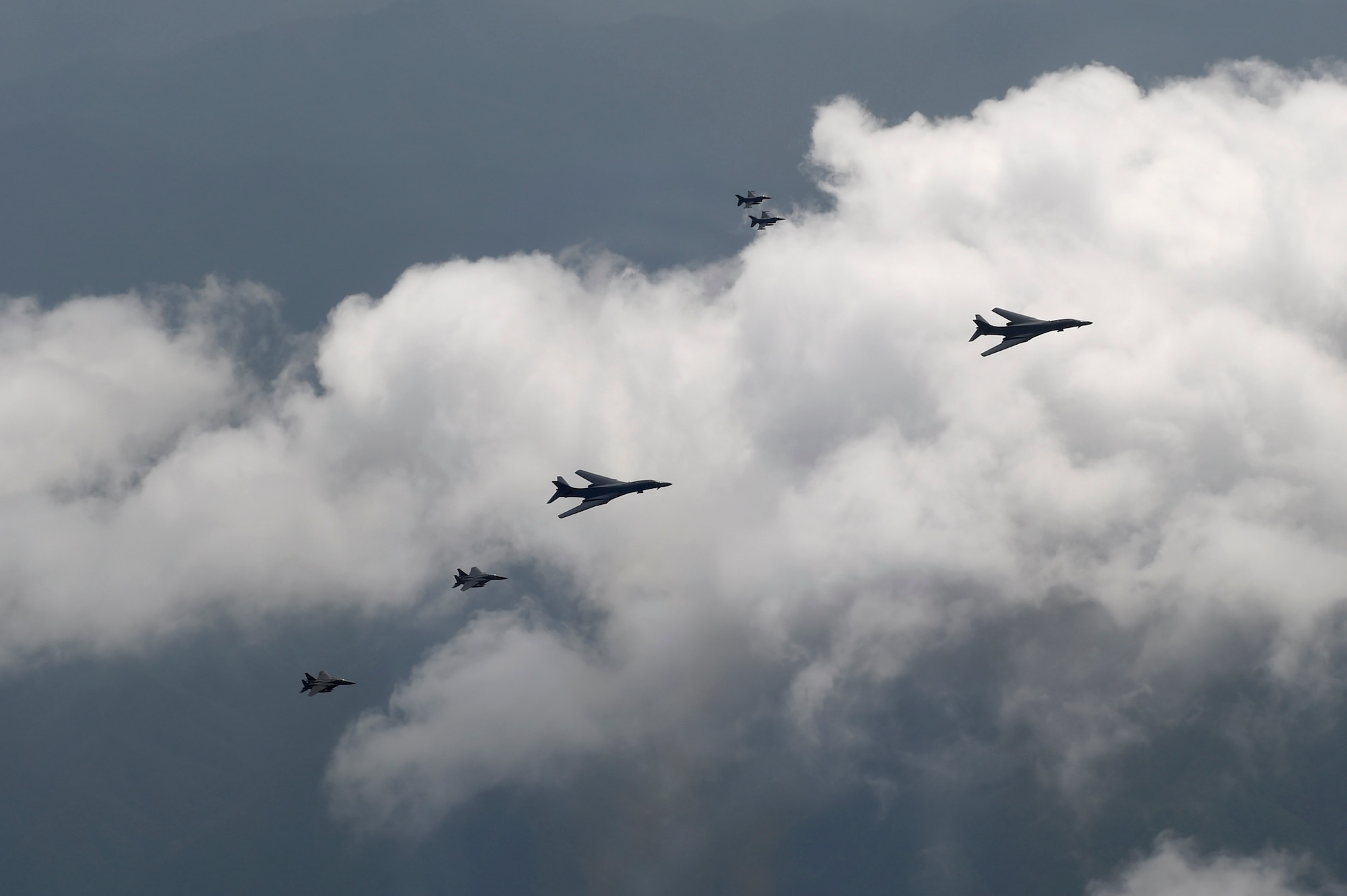 A formation of two B-1B Lancers deployed to Andersen Air Base, Guam, and four F-15K Slam Eagles assigned to Daegu Air Base, Republic of Korea, fly over ROK skies Sept. 21, 2016. The flight was the closest a B-1 has ever flown to the border between the ROK and North Korea. The B-1 is the backbone of the U.S. long-range bomber mission and is capable of carrying the largest payload of both guided and unguided weapons in the Air Force inventory. (Republic of Korea air force photo by Chief Master Sgt. Kim, Kyeong Ryul)