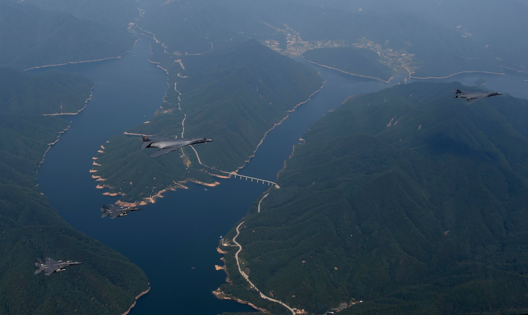Two U.S. Air Force B-1B Lancers deployed to Andersen Air Base, Guam, and two F-15K Slam Eagles assigned to Daegu Air Base, Republic of Korea, fly over ROK skies Sept. 21, 2016. The flight was the closest a B-1 has ever flown to the border between the ROK and North Korea. The B-1 is the backbone of the U.S. long-range bomber mission and is capable of carrying the largest payload of both guided and unguided weapons in the Air Force inventory. (Republic of Korea air force photo by Chief Master Sgt. Kim, Kyeong Ryul)