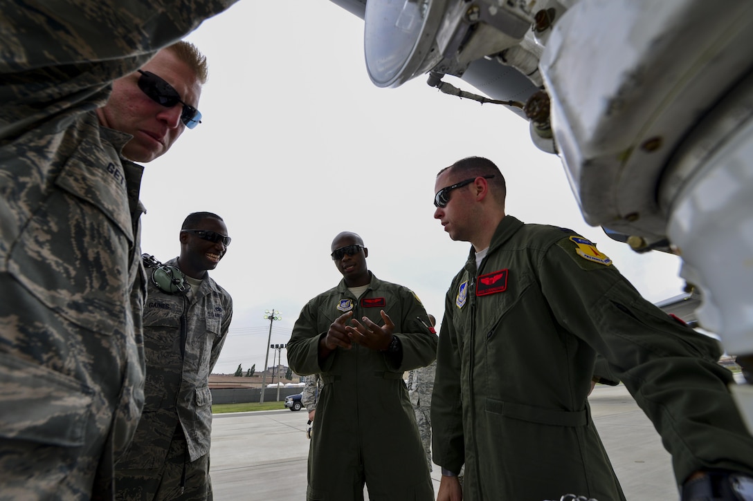 Crew members of a U.S. Air Force B-1B Lancer and maintenance Airmen from the 34th Expeditionary Aircraft Maintenance Unit at Andersen Air Base, Guam, discuss post flight maintenance at Osan Air Base, Republic of Korea, Sept. 21, 2016. The crew landed a B-1 on the Korean Peninsula for the first time since 1996, and also conducted the aircraft’s closest flight to the North Korean border ever. (U.S. Air Force photo by Senior Airman Victor J. Caputo)