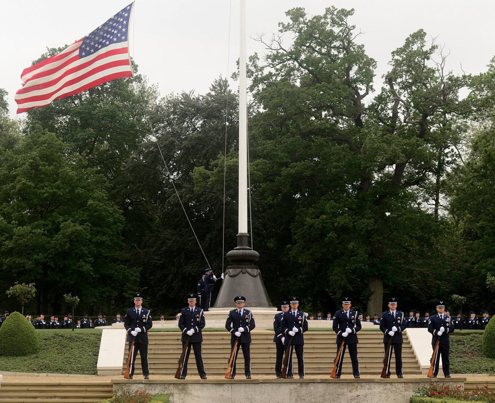 U.S. Air Force Tech. Sgt. James Stay, 100th Logistics Readiness Squadron NCO in charge of Mobility Readiness Spares Packaging, and NCO in charge of Honor Guard, stands behind the firing party while commanding, during a Memorial Day Service, May 30, 2016 at Madingley in Cambridge, England. The Team Mildenhall Honor Guard performs a variety of details throughout England, Wales and Ireland. (Courtesy photo)