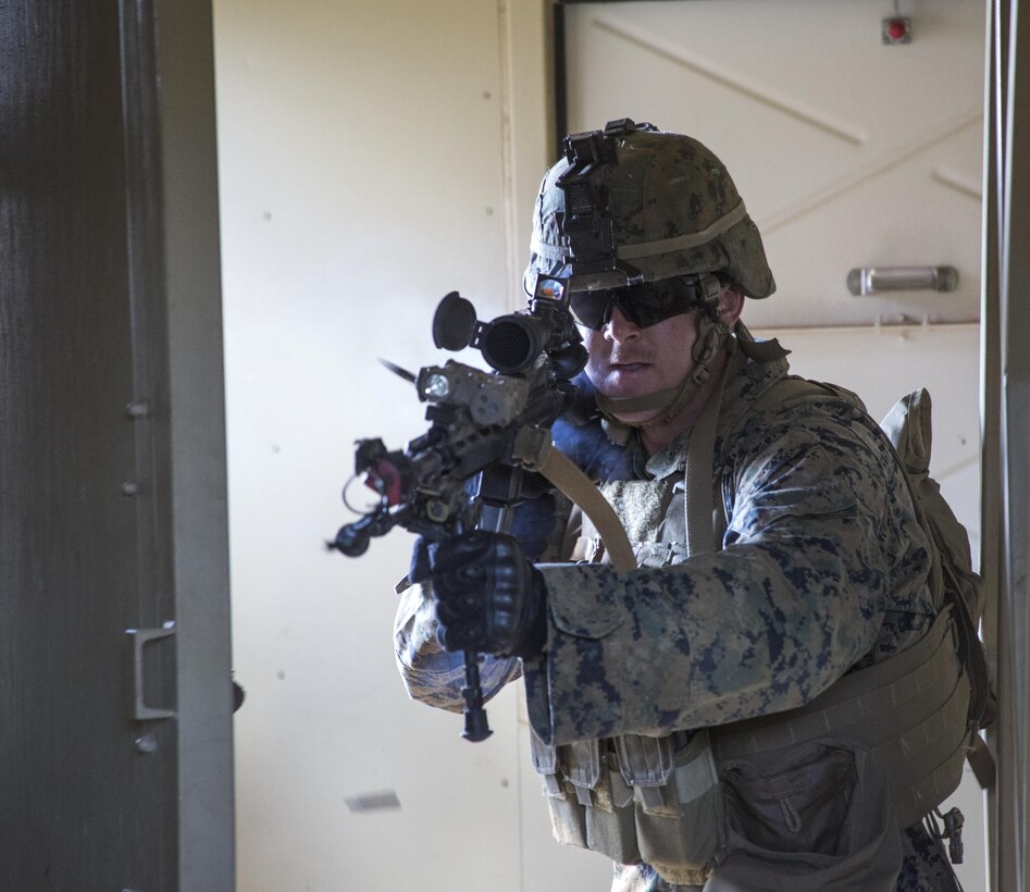 Lance Cpl. Greg Meline with Marine Barracks Washington, D.C., clears a room during the Military Operations in Urban Terrain (MOUT) portion of training for the Fire Team Leaders Course at Marine Corps Base Quantico, Va., Sept. 12, 2016. The FTLC training evolution began last year, making this year's course the second iteration. It is designed to strengthen small unit leadership amongst the Marines to prepare them for the fleet, while focusing on refining their infantry skills. (Official Marine Corps photo by Lance Cpl. Robert Knapp/Released) 