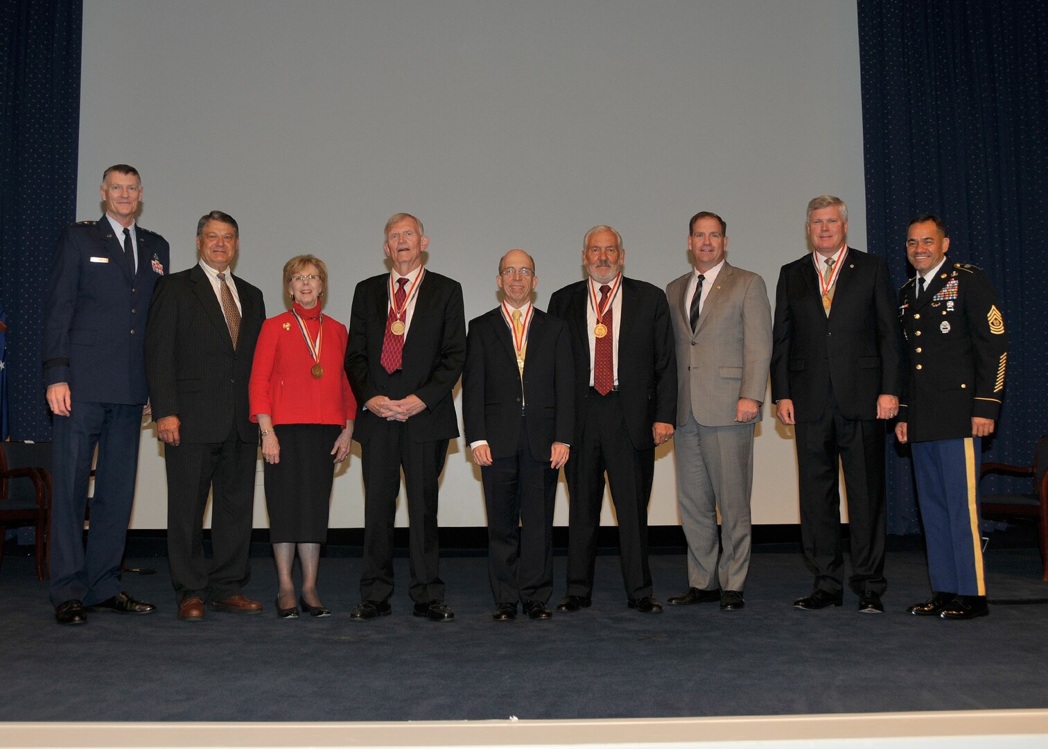 DLA senior leaders and 2015 Hall of Fame honorees at the Sept. 20, 2016, induction ceremony at Fort Belvoir, Virginia. From left: Air Force Lt. Gen. Andy Busch, Albert Kluczynski (on behalf of Paula Kluczynski), Celia Adolphi, David Ennis, Paul Zebrowski, Kent Galbraith, Mike Cannon (on behalf of Krissie Davis), Retired Vice Adm. Al Thompson, and Army Command Sgt. Maj. Charles Tobin.