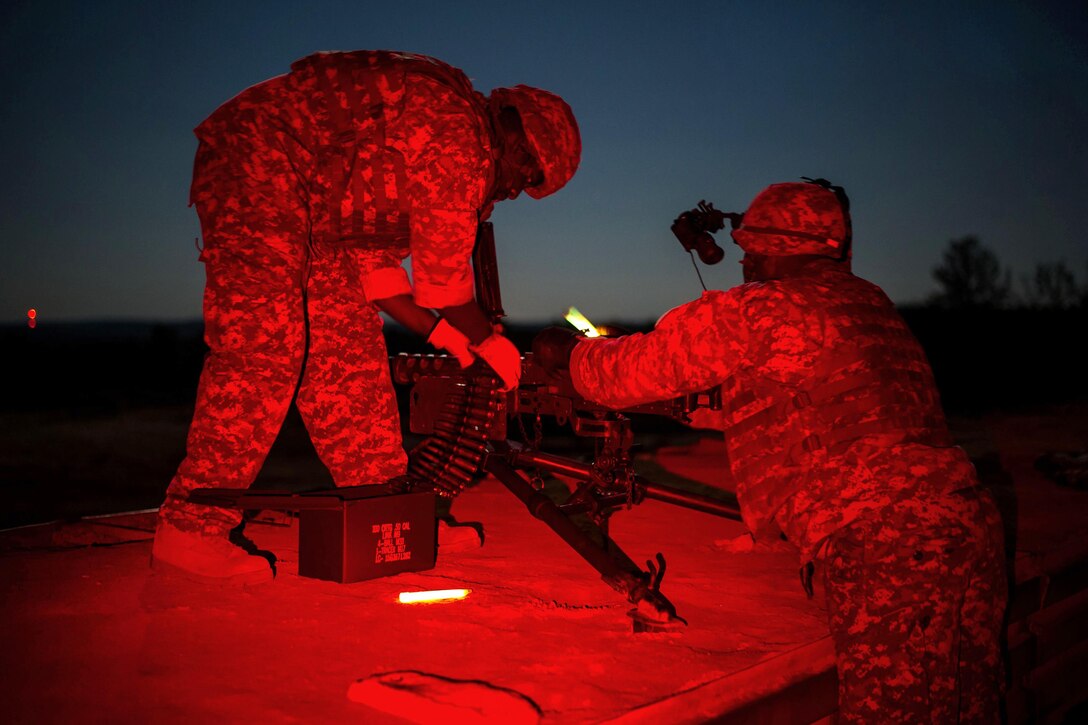 Soldiers load .50-caliber ammunition into an M2 machine gun and position it before live-fire training at Fort Jackson, S.C., Sept. 15, 2016. Air National Guard photo by Tech. Sgt. Jorge Intriago  
