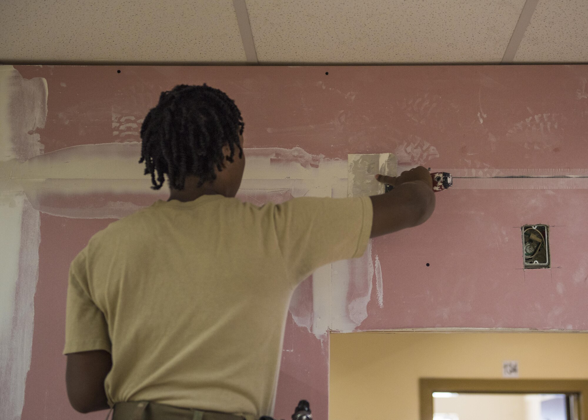 Airman 1st Class Taylor Davis, 455th Expeditionary Civil Engineer Squadron structural journeyman, applies joint compound which helps seal joints between drywall, Bagram Airfield, Afghanistan, Sept. 20, 2016. Structural specialists have a varied skill set that is used along with specialized materials, and equipment to build numerous structures that range from locker rooms to improvised emergency disaster relief shelters. (U.S. Air Force photo by Senior Airman Justyn M. Freeman)