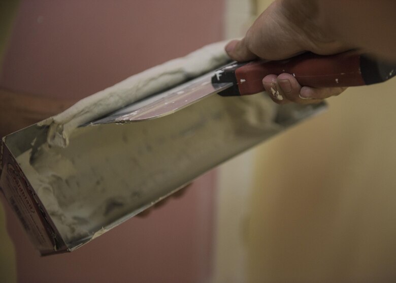 Senior Airman Eric Woolston, 455th Expeditionary Civil Engineer Squadron structural journeyman, applies joint compound which helps seal joints between drywall, Bagram Airfield, Afghanistan, Sept. 20, 2016. Members of the 455th ECES structures flight construct and repair buildings and other military structures from the foundation up. (U.S. Air Force photo by Senior Airman Justyn M. Freeman)