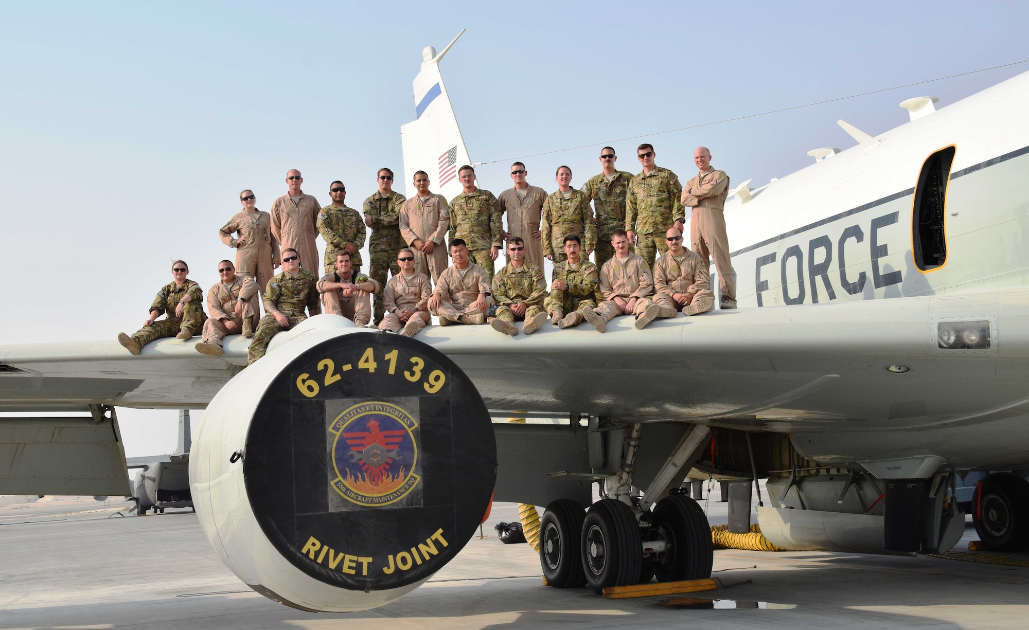 Capt. Shawn Jensen(bottom row third from right), a E-8C Joint Surveillance Target Attack Radar System pilot with the 763rd Expeditionary Reconnaisance Squadron, and his crew posed for a portrait on the wing of their aircraft at Al Udeid Air Base, Qatar, after teturning from a mission in the area of responsibility Sept. 11, 2016. The JSTARS gathers intelligence during its missions in the aor, which contrasts with his grandfather's B-17 Flying Fortress bombing missions for the 379th Bombardmnet Group over Europe in World War II.(U. S. Air Force photo/Tech. Sgt. Carlos J. Trevino/Released)