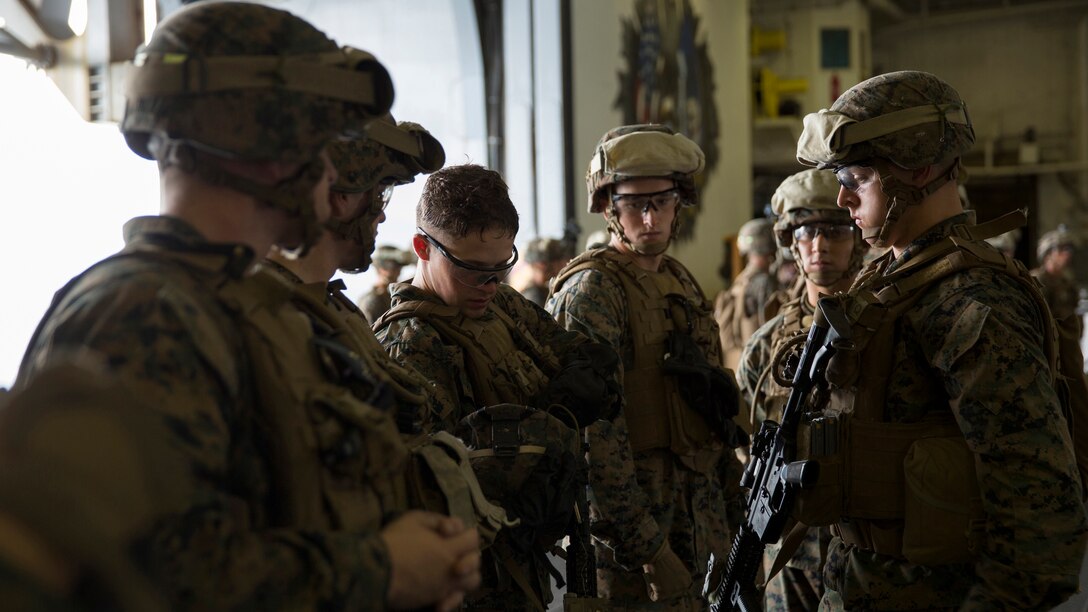 Marines inspect each other’s gear while conducting a drill to better prepare in case of a tactical recovery of aircraft and personnel mission occurs aboard USS Bataan during Amphibious Squadron Marine Expeditionary Unit Integration Training at sea, Sept. 15 2016. PMINT familiarizes Marines and sailors with amphibious operations and to safely execute embarkation training in preparation for future pre-deployment exercises. The Marines are with Battalion Landing Team, 3rd Battalion, 6th Marine Regiment, 24th Marine Expeditionary Unit. 