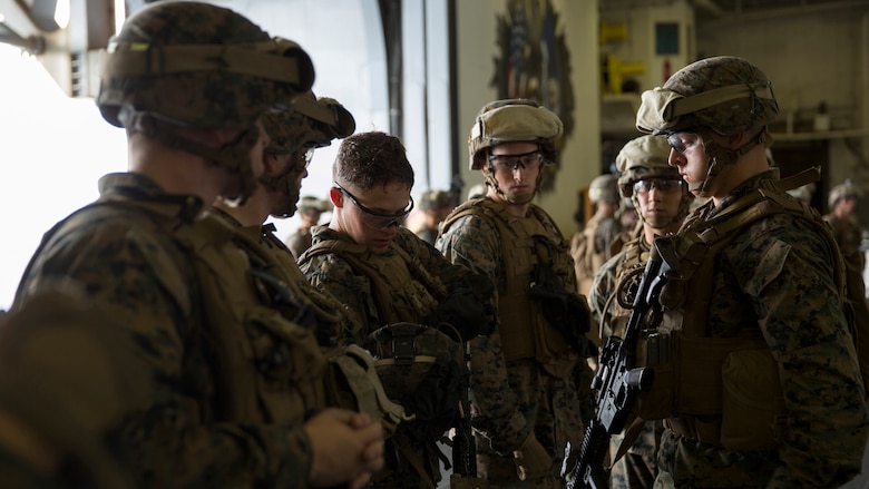 Marines inspect each other’s gear while conducting a drill to better prepare in case of a tactical recovery of aircraft and personnel mission occurs aboard USS Bataan during Amphibious Squadron Marine Expeditionary Unit Integration Training at sea, Sept. 15 2016. PMINT familiarizes Marines and sailors with amphibious operations and to safely execute embarkation training in preparation for future pre-deployment exercises. The Marines are with Battalion Landing Team, 3rd Battalion, 6th Marine Regiment, 24th Marine Expeditionary Unit. 