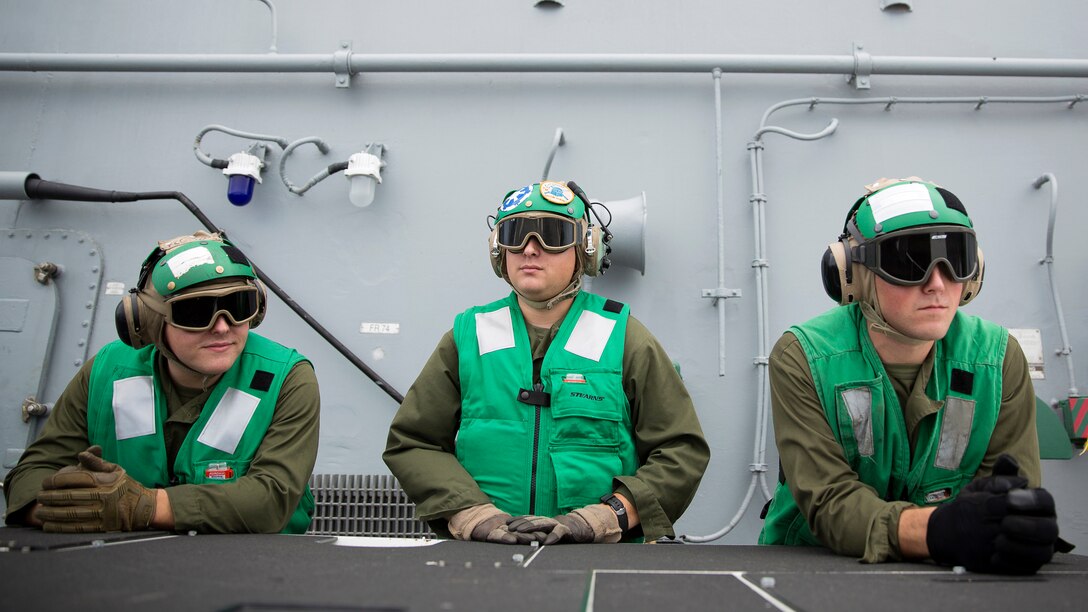 Marines with Marine Medium Tiltrotor Squadron 365 observe aircraft depart USS Bataan during Amphibious Squadron Marine Expeditionary Unit Integration Training at sea, Sept. 15 2016. PMINT familiarizes Marines and sailors with amphibious operations and to safely execute embarkation training in preparation for future pre-deployment exercises. 