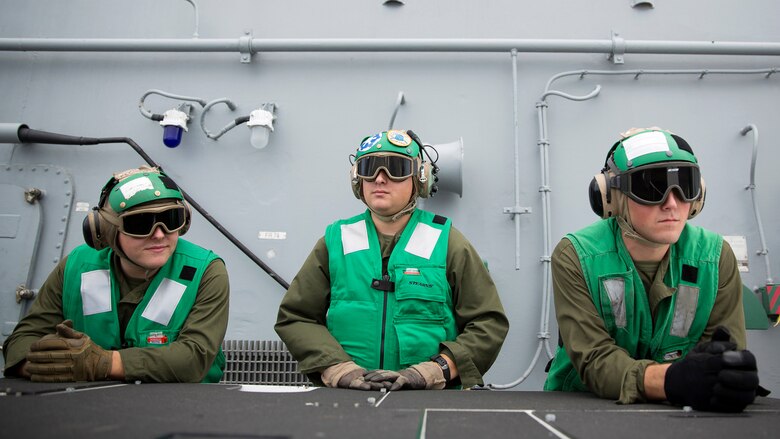 Marines with Marine Medium Tiltrotor Squadron 365 observe aircraft depart USS Bataan during Amphibious Squadron Marine Expeditionary Unit Integration Training at sea, Sept. 15 2016. PMINT familiarizes Marines and sailors with amphibious operations and to safely execute embarkation training in preparation for future pre-deployment exercises. 