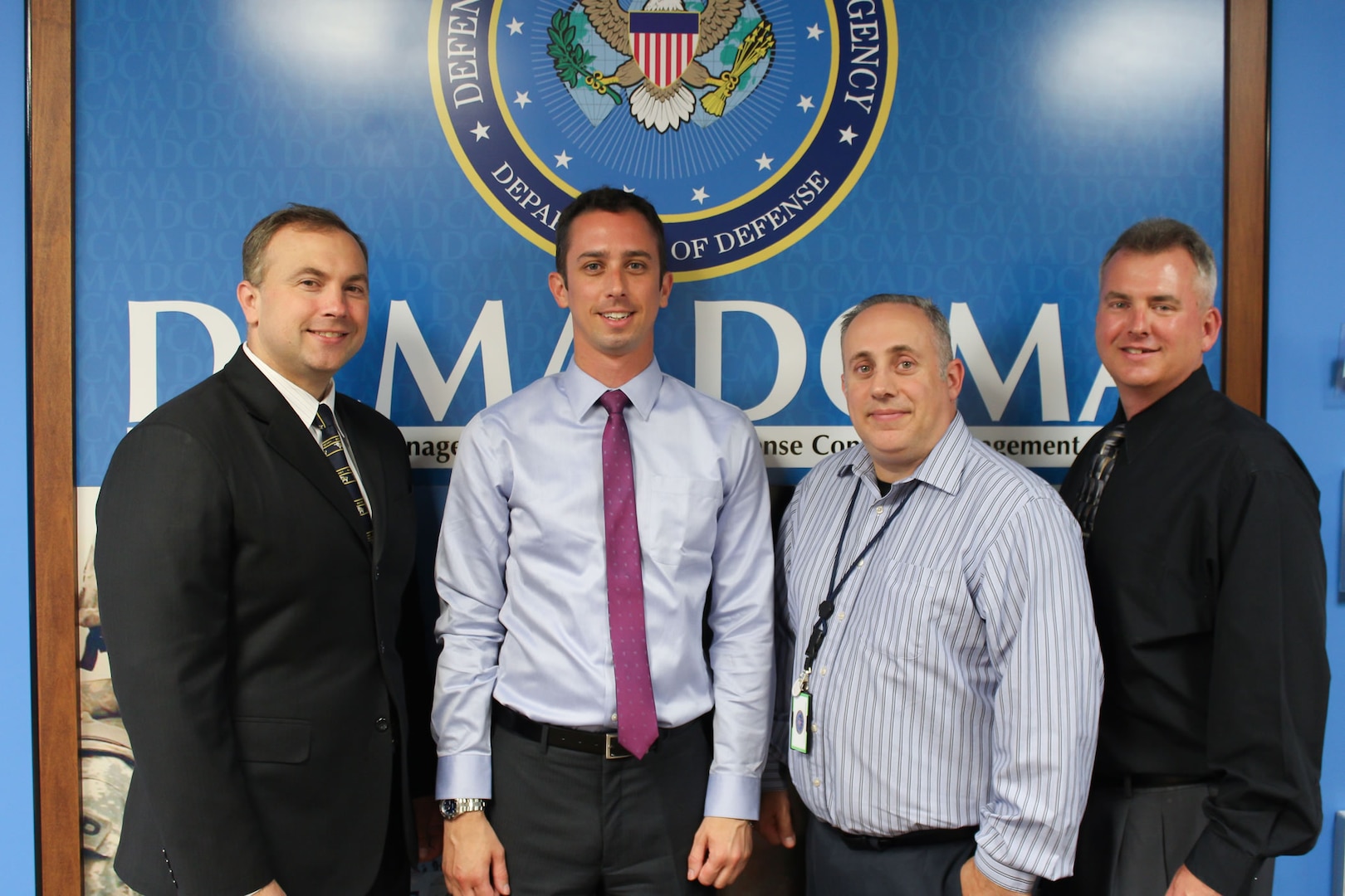 In addition to their civilian job duties, several Defense Contract Management Agency Garden City employees from New York also serve in the reserve or National Guard. (From left) Cliff Allen, an attorney who is in the Navy Reserve; Doug Nelson, an administrative contracting officer who also serves in the Navy Reserve; Tom Valentino, a quality assurance specialist who serves in the Air Force Reserve; and Malcolm Timoney, a quality assurance specialist who recently retired from the Air National Guard. 