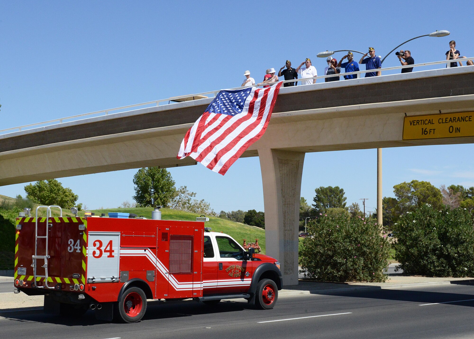 An Edwards Air Force Base Fire Department truck approaches an overpass on California City Blvd. during a memorial procession Sept. 19. About 120 representatives from agencies across California participated to show support for fallen K-9 officer Ty from the California City Police Department. (U.S. Air Force photo by Kenji Thuloweit)