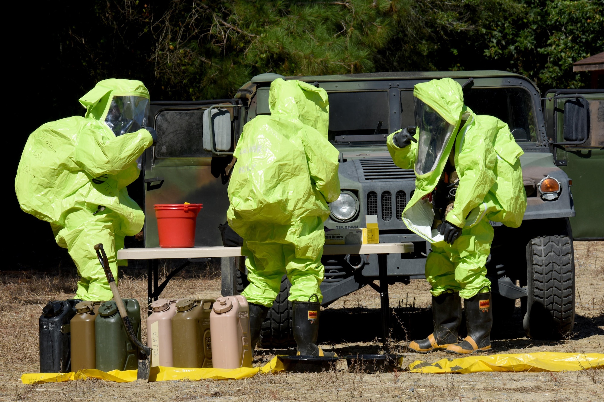 Three explosive ordnance disposal technicians from the 4th Civil Engineer Squadron, simulate a chemical spill and cleanup during a three-day EOD exercise, Sept. 15, 2016, on the EOD range at Seymour Johnson Air Force Base, North Carolina. The last day of the three-day exercise focused on chemical, biological, radiological and nuclear defense training. (U.S. Air Force photo by Airman Miranda A. Loera)