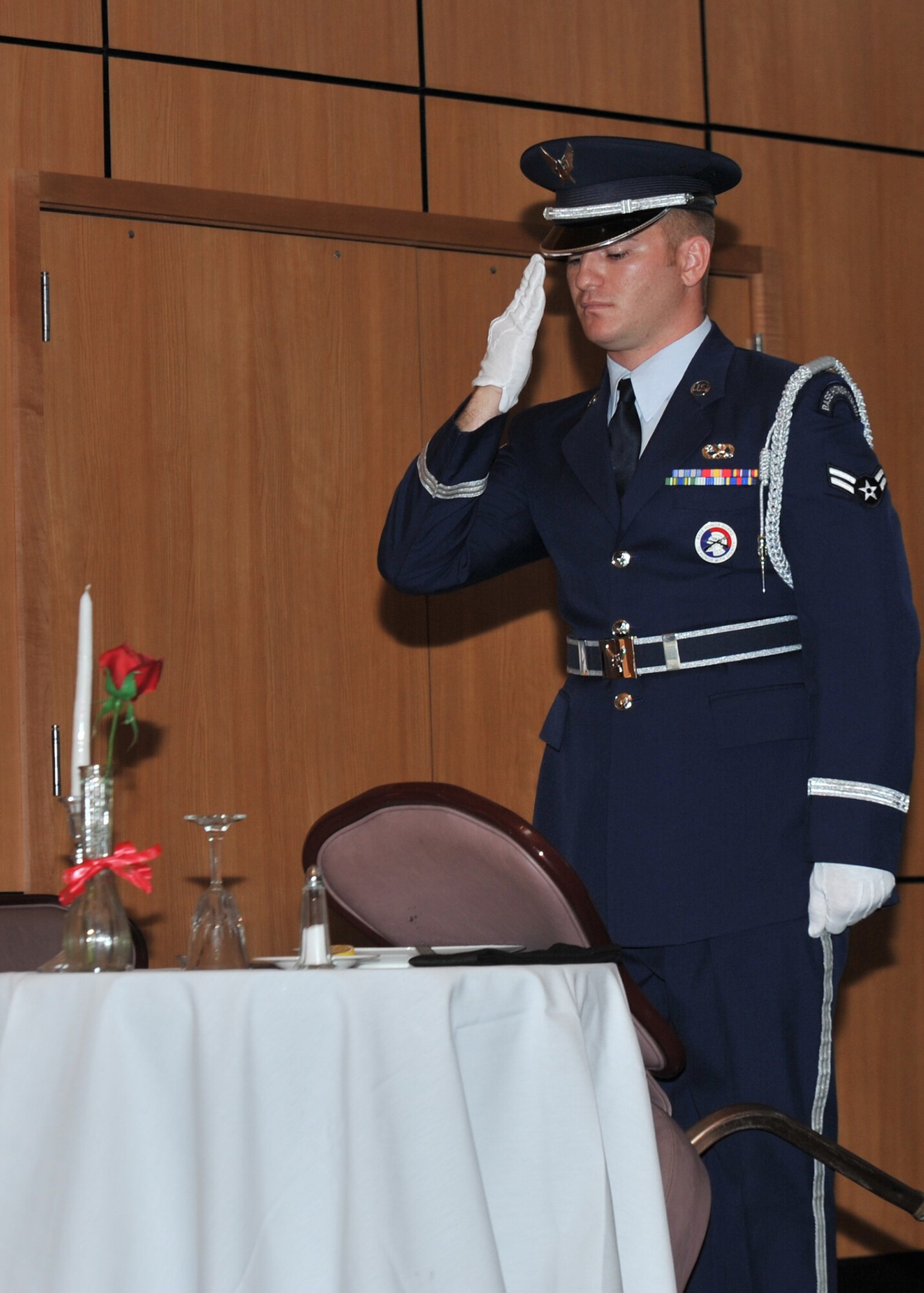 U.S. Air Force Airman 1st Class Steven Mashke, 325th Force Support Squadron ceremonial guardsman, renders a salute during the POW/MIA luncheon at the Horizons Community Center on Tyndall AFB, Fla., Sept. 20, 2016. The POW/MIA ceremony is performed in recognition to service-members who are prisoners of war or missing in action. (U.S. Air Force photo by Senior Airman Ty-Rico Lea/Released)