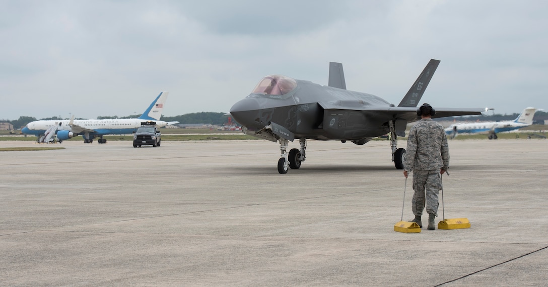 A member from Joint Base Andrews, Md., prepares to place chocks for an F-35 Lightning II on base, Sept. 20, 2016. The aircraft is here to perform a fly-over during the U.S. Air Force Tattoo at Joint Base Anacostia-Bolling, D.C., Sept. 22, 2016. (U.S. Air Force photo by Airman Gabrielle Spalding)