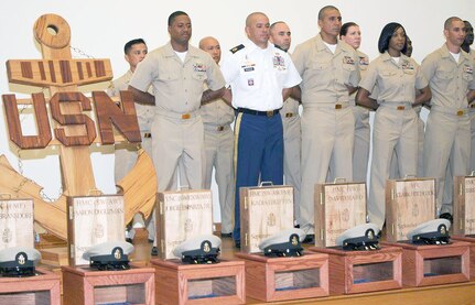 Navy Chief Petty Officer selectees wait to be “pinned” with their Chief Petty Officer anchors and presented their combination cover at Joint Base San Antonio-Fort Sam Houston Friday. With the Navy chiefs is Army Sgt. 1st Class Dan Hitchcock, NCO in charge of the Combat Casualty Care Force at the Defense Medical Readiness Training Institute at JBSA-Fort Sam Houston and the son of retired Master Chief Hospital Corpsman Clark Hitchcock. Hitchcock participated in Navy Medicine San Antonio’s CPO 365 Phase 2 Training, a Navy-wide program of intense leadership, physical fitness and Navy heritage training for CPO selectees, and was pinned and presented his combination cover. 