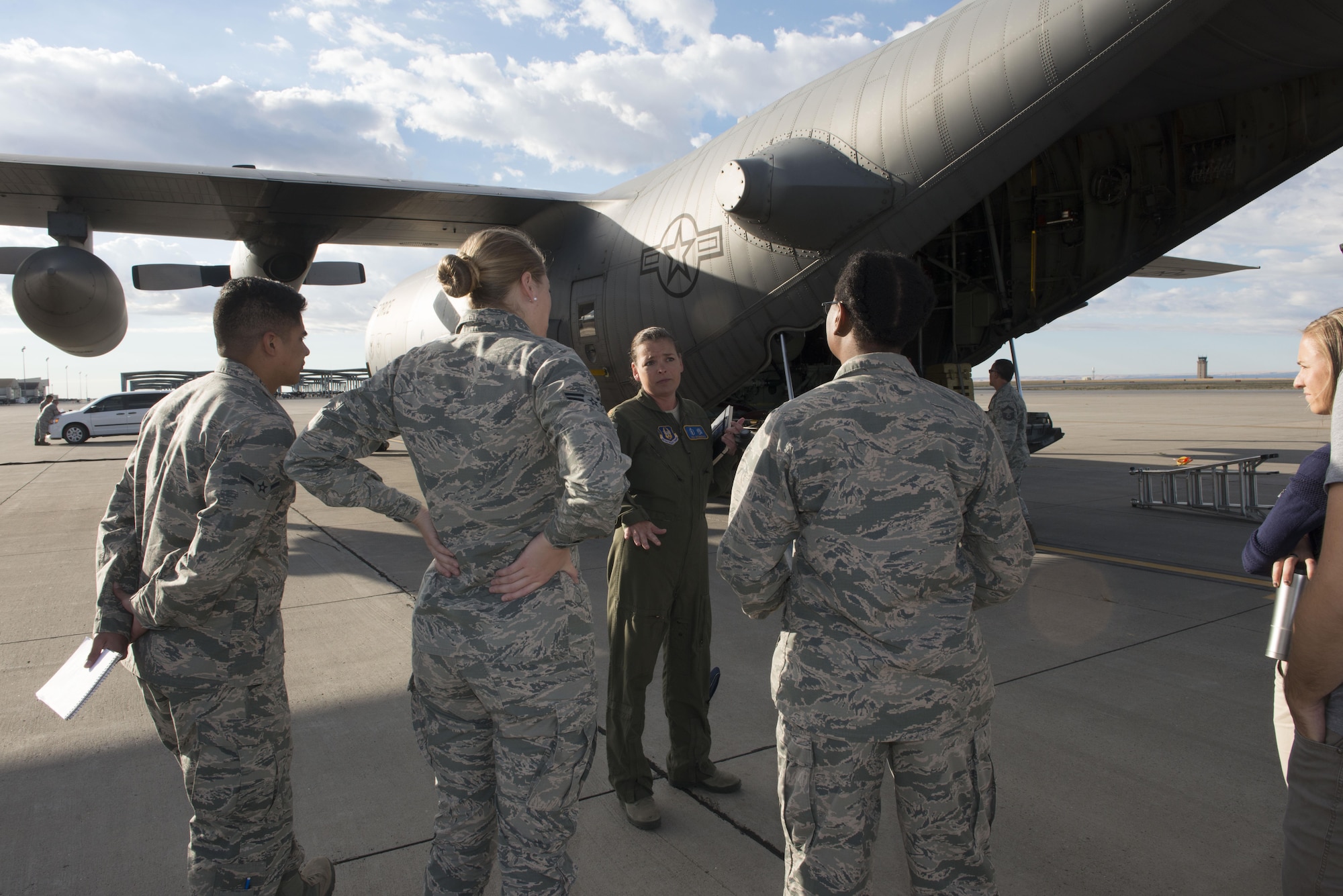 Maj. Jen Remmers, 910th Air Wing aerial spray team pilot, explains their mission of the aerial spray team, September 19, 2016, at Mountain Home Air Force Base, Idaho. A group of individuals from the 366th Civil Engineer Squadron and the Aerospace Medicine Squadron bioenvironmental flight had the opportunity to tour the C-130 and hear about its capabilities. (U.S. Air Force photo by Senior Airman Malissa Lott/Released)