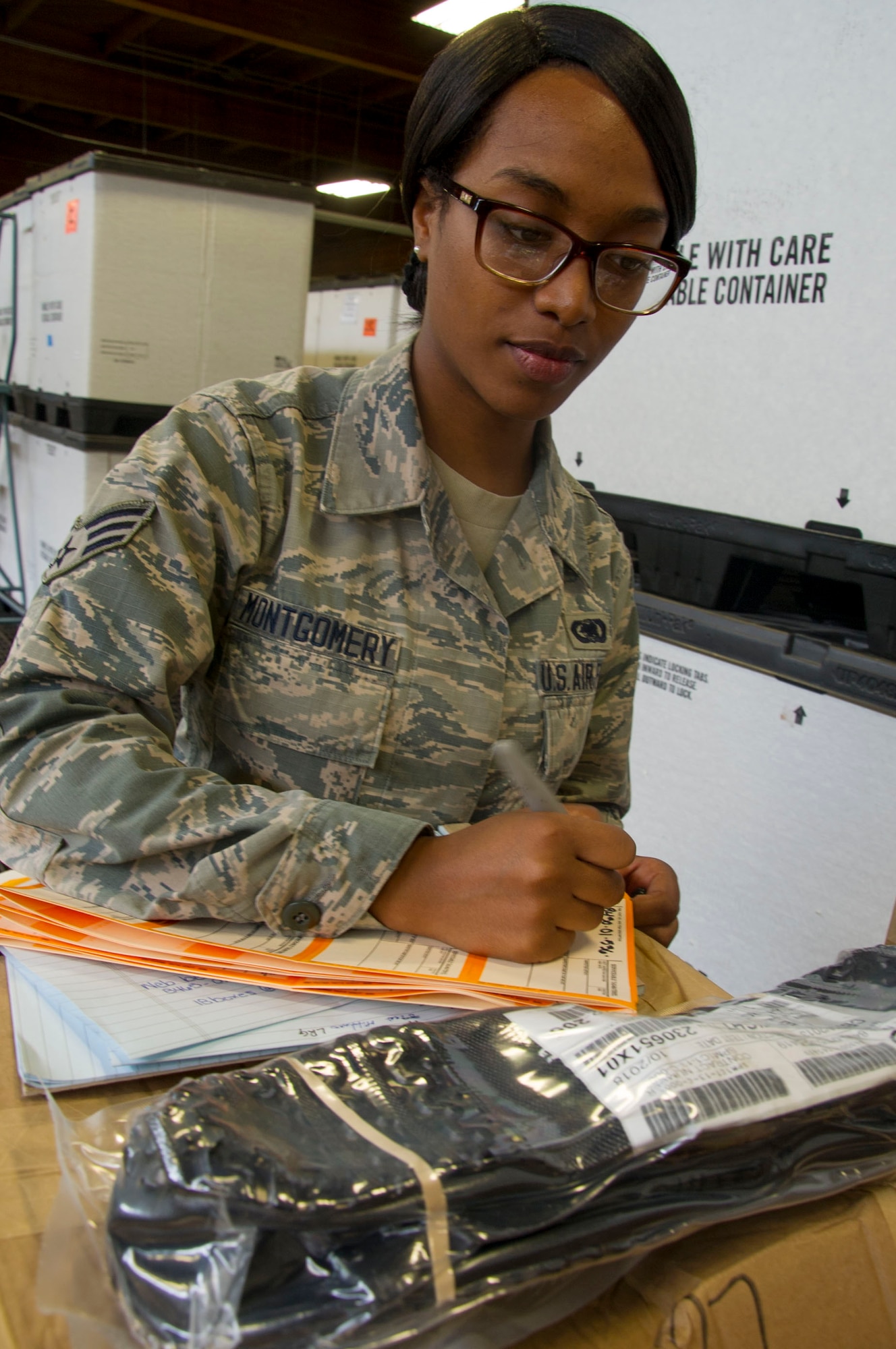 Senior Airman Victoria Montgomery, an inventory management journeyman with the 446th Logistics Readiness Flight, takes inventory of overboots July 9, 2016, in the base warehouse at McChord Field. Montgomery integrated with the 62nd Logistics Readiness Squadron and provided support to F-16 missions that led to the initial production lot of the KC-46A Pegasus. (U.S. Air Force Reserve photo by Master Sgt. Minnette Mason)