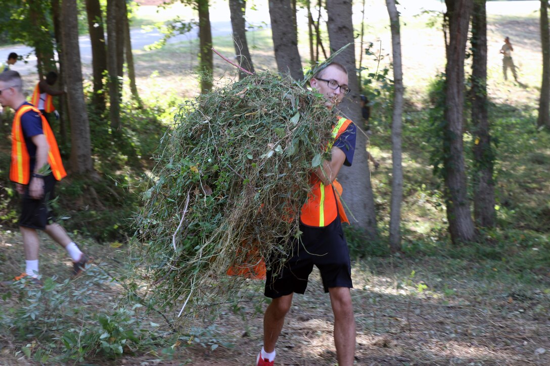 Poolee from Marine Corps Recruiting Substation Anderson, removes weeds from the Equinox Park in Anderson, S.C. on Saturday. The poolees came to the park with their Marine Corps recruiters to help clean.
