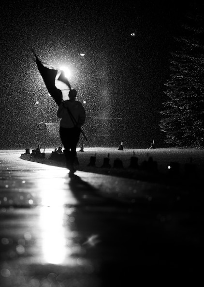 A Team Minot Airman carries the Prisoners of War/Missing in Action flag through the rain at Minot Air Force Base, N.D., Sept. 15, 2016. The POW/MIA flag was carried around the outdoor track for 24 hours, while the names of those who are lost but not forgotten were read aloud in remembrance. (Airman 1st Class J.T. Armstrong)