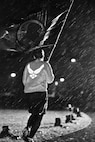 A Team Minot Airman carries the Prisoners of War/Missing in Action flag through the rain at Minot Air Force Base, N.D., Sept. 15, 2016. The POW/MIA flag was carried around the outdoor track for 24 hours, while the names of those who are lost but not forgotten were read aloud in remembrance. (Airman 1st Class J.T. Armstrong)