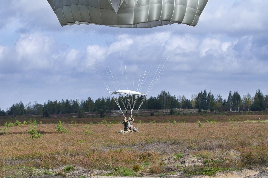 A paratrooper lands after participating in airborne operations during exercise Bayonet Strike at a drop zone near Adazi, Latvia, Sept. 12, 2016. Army photo by Pfc. James Dutkavich
