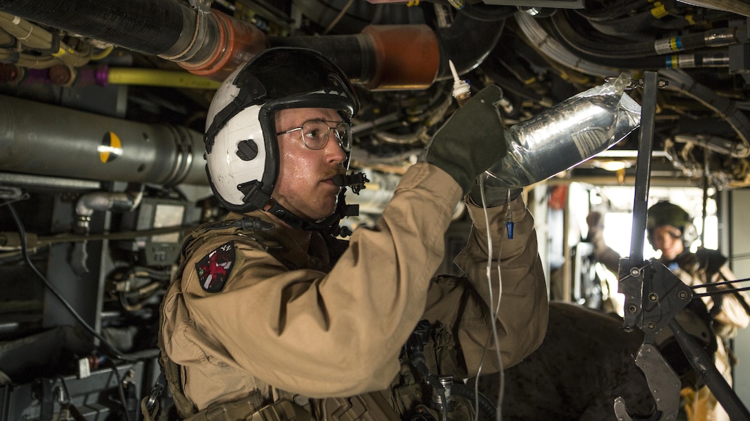 U.S. Navy Lt. Daniel Neubauer, a flight surgeon with Marine Medium Tiltrotor Squadron 363, Special Purpose Marine Air-Ground Task Force - Crisis Response - Central Command, prepares an intravenous fluid bag during a mass casualty exercise at an undisclosed location in Southwest Asia, Aug. 29, 2016. The exercise was conducted to ensure an effective response to a MASCAL situation in a joint environment.