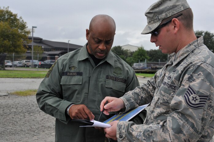 Detective Carl Makins, a hazardous device technician with the Charleston County Sheriff's Office, reviews a training scenario with Tech. Sgt. Jon Morrison, 628th Civil Engineer Squadron Explosive Ordnance Disposal quality assurance section chief, during a training exercise here, Sept. 21, 2016. The local bomb squads often train with members from the 628th Civil Engineer Squadron's Explosive Ordnance Disposal flight to build relationships and streamline operating procedures between state and federal entities.