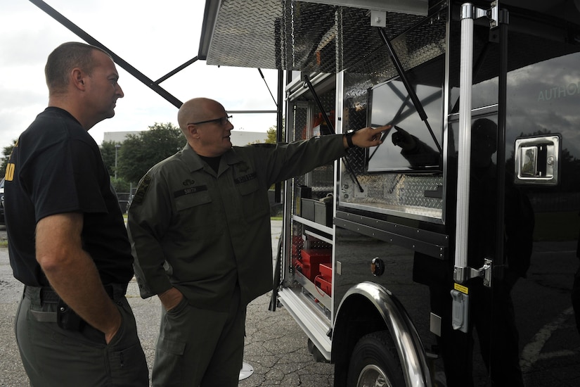 Master Deputy Billy Brinson, and Detective Rob Smith, hazardous device technicians with the Charleston County Sheriff's Office bomb squad, review footage from a bomb disposal robot during a training exercise here, Sept. 21, 2016. The 628th Civil Engineer Squadron's Explosive Ordnance Disposal flight frequently trains with the local counterparts to maintain continuity between federal and state departments.