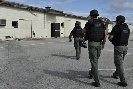 Detective Carl Makins (left), Master Deputy James Thomas and Detective Rob Smith, hazardous device technicians with the Charleston County Sheriff's Office, proceed to a cleared scene during a training exercise at Joint Base Charleston, South Carolina, Sept. 16, 2016. Makins is also a master sergeant in the 315th Airlift Wing reserve unit as an explosive ordnance disposal technician.