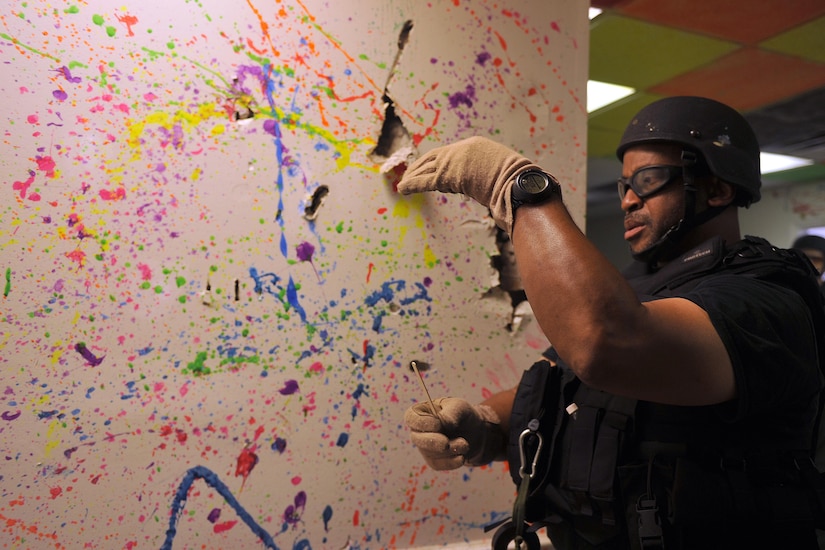 Detective Carl Makins, a hazardous device technician with the Charleston County Sheriff's Office, examines a powder sample from an exploded ordnance during a training exercise here Sept 21, 2016. The local bomb squads often train with members from the 628th Civil Engineer Squadron's Explosive Ordnance Disposal flight to build relationships and streamline operating procedures between state and federal entities.