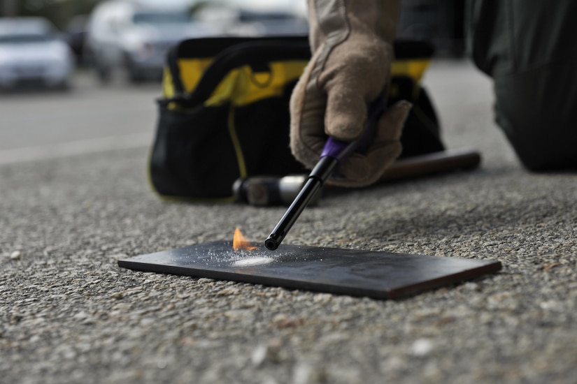 Detective Carl Makins, a hazardous device technician with the Charleston County Sheriff's Office, examines a powder sample from an exploded ordnance during a training exercise here Sept 21, 2016. The local bomb squads often train with members from the 628th Civil Engineer Squadron's Explosive Ordnance Disposal flight to build relationships and streamline operating procedures between state and federal entities.