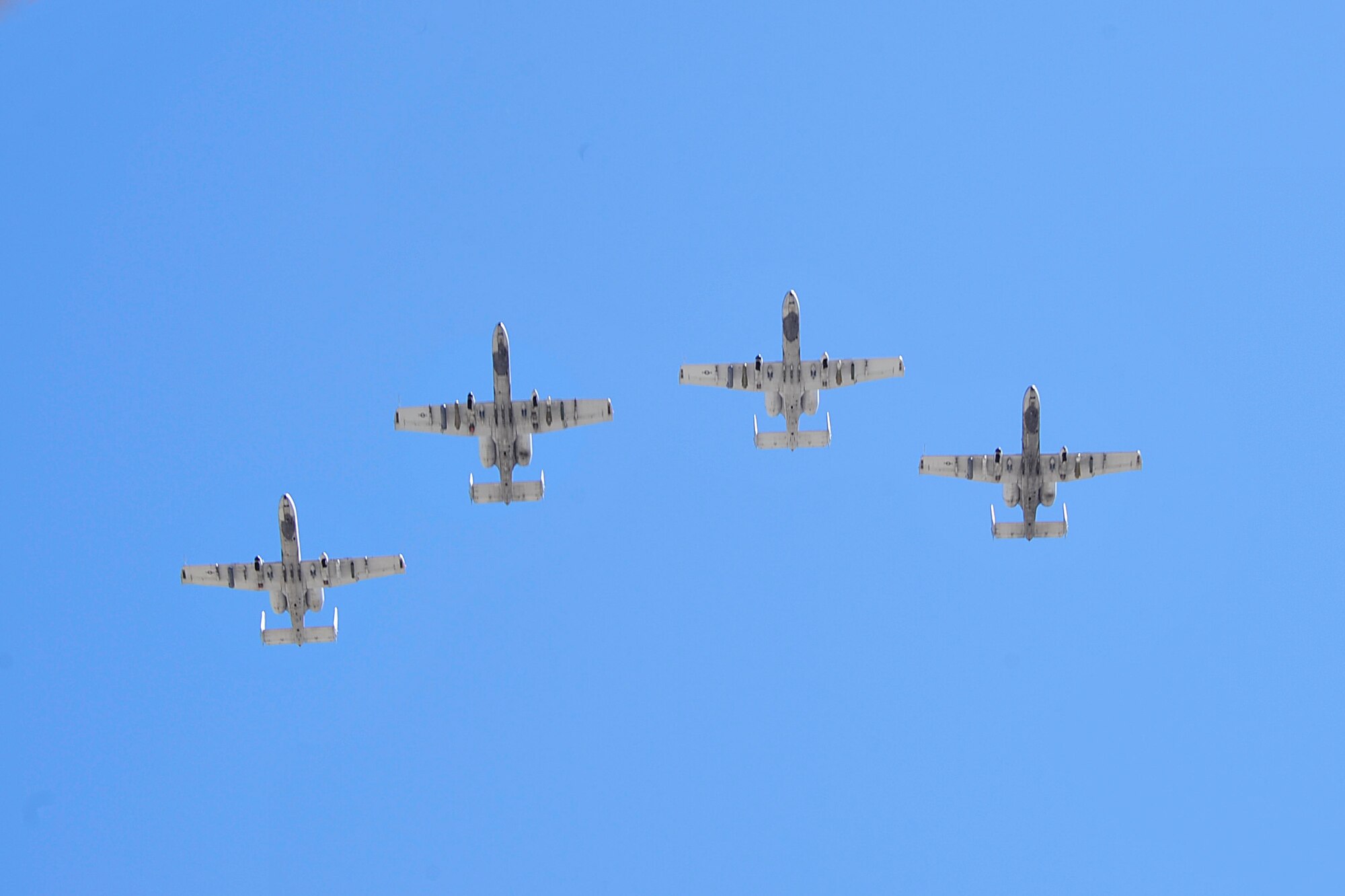 Four A-10C Thunderbolt IIs from the 354th Fighter Squadron perform a missing man flyover during a POW/MIA recognition ceremony at the Veterans Affairs main campus in Tucson, Ariz., Sept. 16, 2016. During the flyover a single A-10 broke away from the formation to symbolize the service members who are still missing in action. (U.S. Air Force photo by Senior Airman Cheyenne A. Powers) 