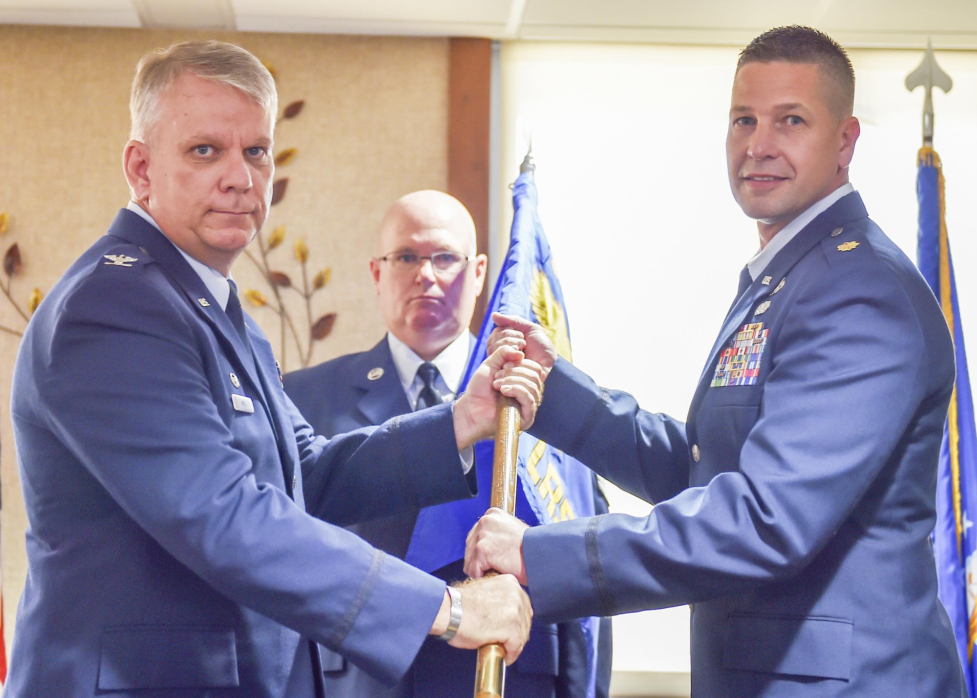 Maj. Robert Wengerter, new commander of the 910th Logistics Readiness Squadron, receives a unit guidon, or flag, from Col. Donald Wren, 910th Mission Support Group commander here, Sept. 10, 2016. Wengerter assumed command of his new squadron at a ceremony during the Unit Training Assembly (UTA). (U.S. Air Force photo/Staff Sgt. Rachel Kocin)