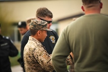 Mongolian Armed Forces Senior Sgt. Mandaa Bayarsukh discusses riot control techniques with U.S. Marines with 3rd Law Enforcement Battalion, III Marine Expeditionary Force,  during Non-Lethal Executive Seminar (NOLES) 2016 at the Five Hills Training Area, Mongolia, Sept. 19, 2016. Mongolian soldiers and National Police rehearsed various riot control formations. Non-lethal weapons are designed to incapacitate equipment and personnel while minimizing fatalities and permanent injury to personnel, and undesired collateral damage to property. 