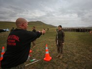 U.S. Marine Staff Sgt. Joseph Ross sprays a Mongolian Armed Forces soldiers with oleoresin capsicum during Non-Lethal Weapons Executive Seminar (NOLES) 2016 at the Five Hills Training Area, Mongolia, Sept. 17, 2016. Ross is a platoon sergeant with 1st Platoon, A Company, 3rd Law Enforcement Battalion, III Marine Expeditionary Force.  Mongolian soldiers and National Police were exposed to oleoresin capsicum spray and had to complete a five-level circuit course. Non-lethal weapons are designed to incapacitate equipment and personnel while minimizing fatalities and permanent injury to personnel, and undesired collateral damage to property.(U.S. Marine Corps photo by Cpl. Jonathan E. LopezCruet)
