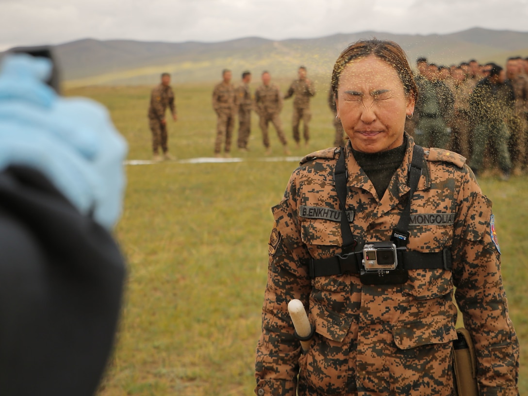 A U.S. Marine sprays Mongolian Armed Forces Junior Sgt. Battsend Enkhtuya with oleoresin capsicum during Non-Lethal Weapons Executive Seminar (NOLES) 2016 at the Five Hills Training Area, Mongolia, Sept. 17, 2016. Mongolian soldiers and National Police were exposed to oleoresin capsicum spray and had to complete a five-level circuit course. Non-lethal weapons are designed to incapacitate equipment and personnel while minimizing fatalities and permanent injury to personnel, and undesired collateral damage to property. (U.S. Marine Corps photo by Cpl. Jonathan E. LopezCruet)