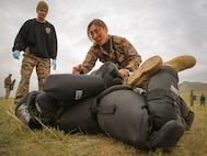 Mongolian Armed Forces Junior Sgt. Battsend Enkhtuya executes a mechanical advantage control holds technique after being sprayed with oleoresin capsicum during Non-Lethal Weapons Executive Seminar (NOLES) 2016 at the Five Hills Training Area, Mongolia, Sept. 17, 2016. Mongolian soldiers and National Police were exposed to Oleoresin Capsicum (OC) spray. Mongolian soldiers and National Police were exposed to oleoresin capsicum spray and had to complete a five-level circuit course. Non-lethal weapons are designed to incapacitate equipment and personnel while minimizing fatalities and permanent injury to personnel, and undesired collateral damage to property. 