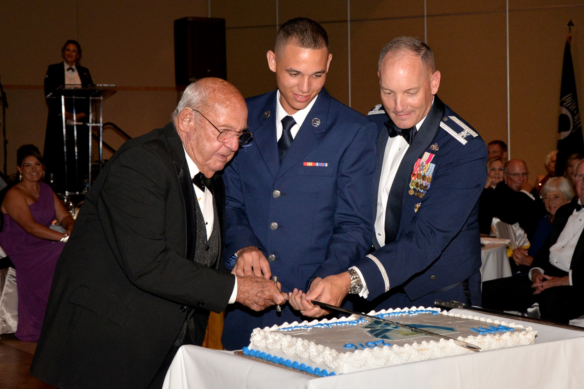U.S. Air Force retired Col. Charles Powell, Airman Alex Bridgewater, 312th Training Squadron student, and Col. Michael Downs, 17th Training Wing Commander, cut a cake in celebration of the U.S. Air Force’s 69th birthday during Goodfellow Air Force Base’s Annual Air Force Ball at the McNease Convention Center in San Angelo, Texas, Sept. 16, 2016. It is a long-held tradition that the birthday cake is cut by the most senior member or veteran and youngest member present. (U.S. Air Force photo by Airman 1st Class Randall Moose/Released)