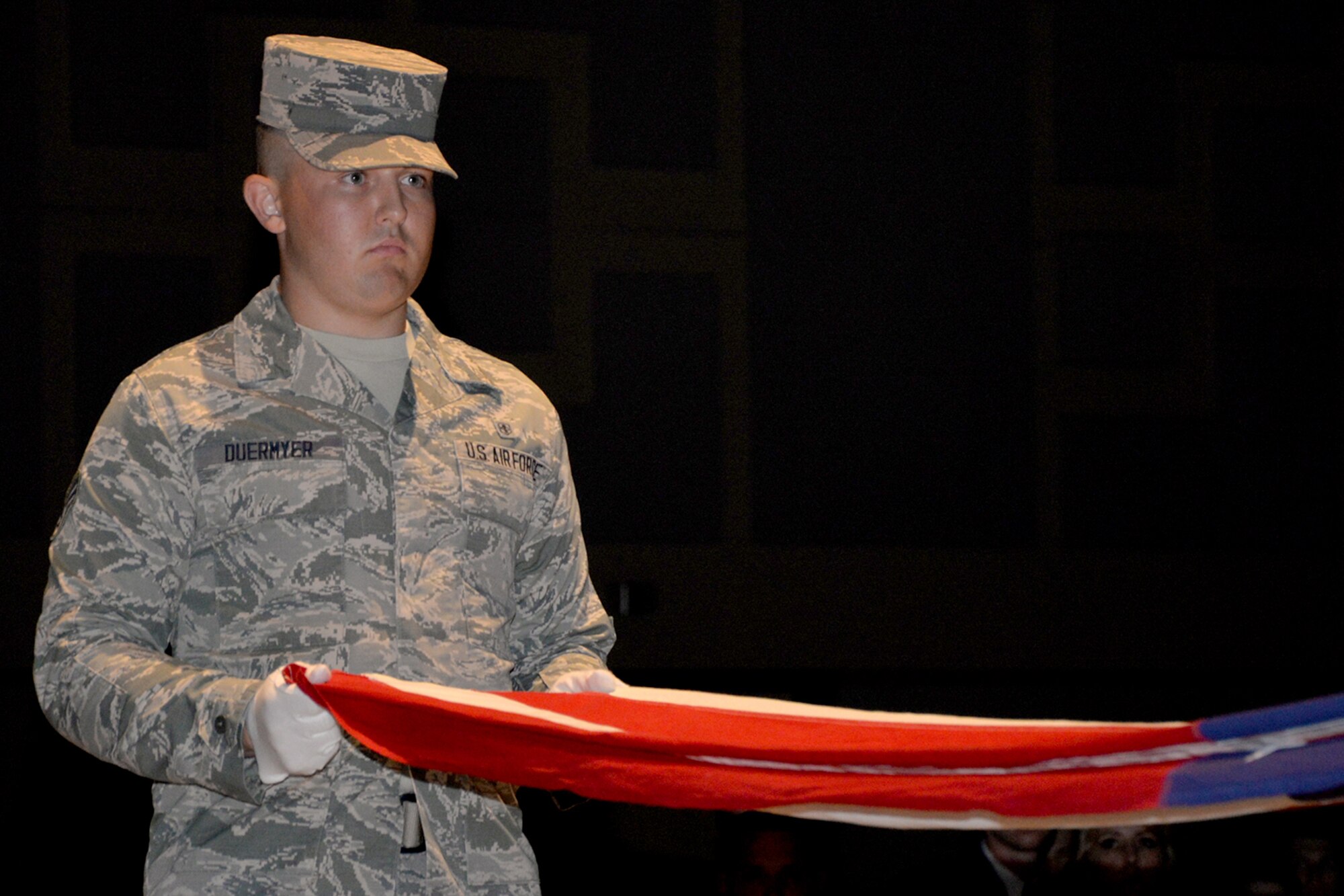 U.S. Air Force Senior Airman Dillon Duermyer, 17th Medical Support Squadron Clinical Medicine Flight administrator, folds the American flag as part of a retreat ceremony during Goodfellow Air Force Base’s Annual Air Force Ball at the McNease Convention Center in San Angelo, Texas, Sept. 16, 2016. The flag folding ceremony paid tribute to all Airmen, past and present. (U.S. Air Force photo by Airman 1st Class Randall Moose/Released)
