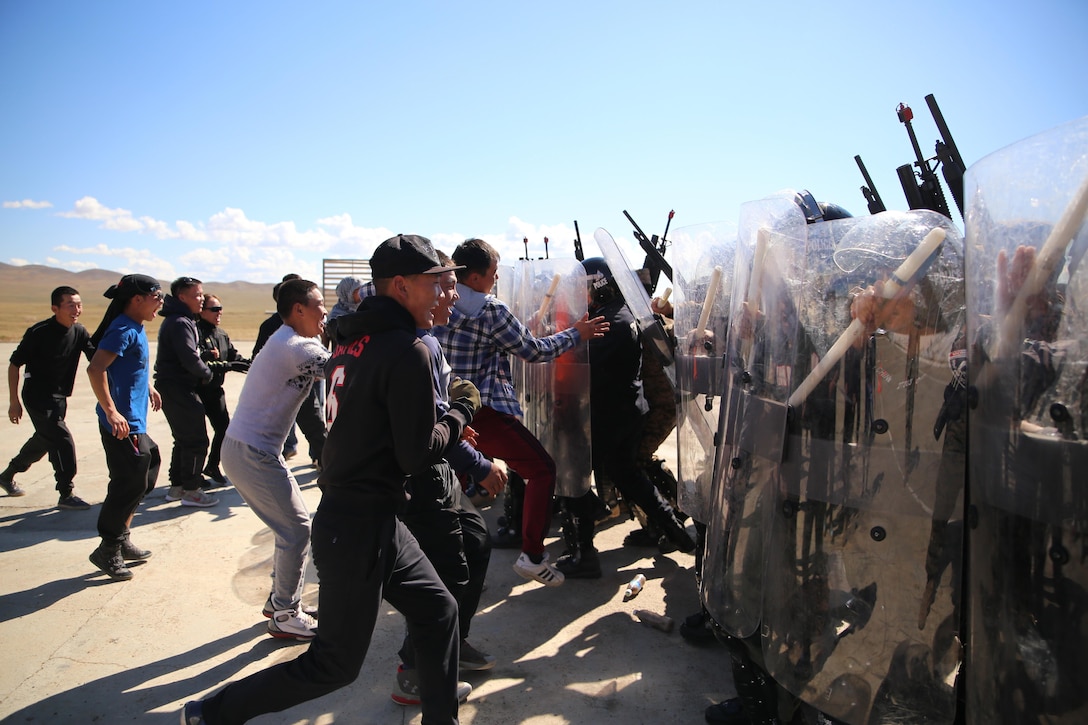 A hostile crowd approach Mongolian Armed Forces soldiers and Mongolian National Police during a simulated riot for Non-Lethal Executive Seminar (NOLES) 2016 at Five Hills Training Area, Mongolia, Sept. 20, 2016. Mongolian soldiers and National Police completed the final portion of the field training exercise for NOLES with a riot control situation. Non-lethal weapons are designed to incapacitate equipment and personnel while minimizing fatalities and permanent injury to personnel, and undesired collateral damage to property. 