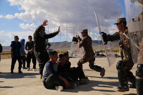 Mongolian Armed Forces soldiers and Mongolian National Police practice riot control techniques during Non-Lethal Executive Seminar (NOLES) 2016 at Five Hills Training Area, Mongolia, Sept. 20, 2016. The final portion of the field training exercise for NOLES included a riot control situation. Non-lethal weapons are designed to incapacitate equipment and personnel while minimizing fatalities and permanent injury to personnel, and undesired collateral damage to property. 