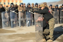U.S. Marine Cpl. Ezequiel Silva and Cpl. Samuel Masse, both military police Marines with 3rd Law Enforcement Battalion, III Marine Expeditionary Force, demonstrate proper use of non-lethal weapons during the riot control portion Non-Lethal Executive Seminar (NOLES) 2016 at Five Hills Training Area, Mongolia, Sept. 20, 2016. Mongolian soldiers and National Police completed the final portion of the field training exercise for NOLES with a riot control situation. Non-lethal weapons are designed to incapacitate equipment and personnel while minimizing fatalities and permanent injury to personnel, and undesired collateral damage to property. (U.S. Marine Corps photo by Cpl. Jonathan E. LopezCruet)