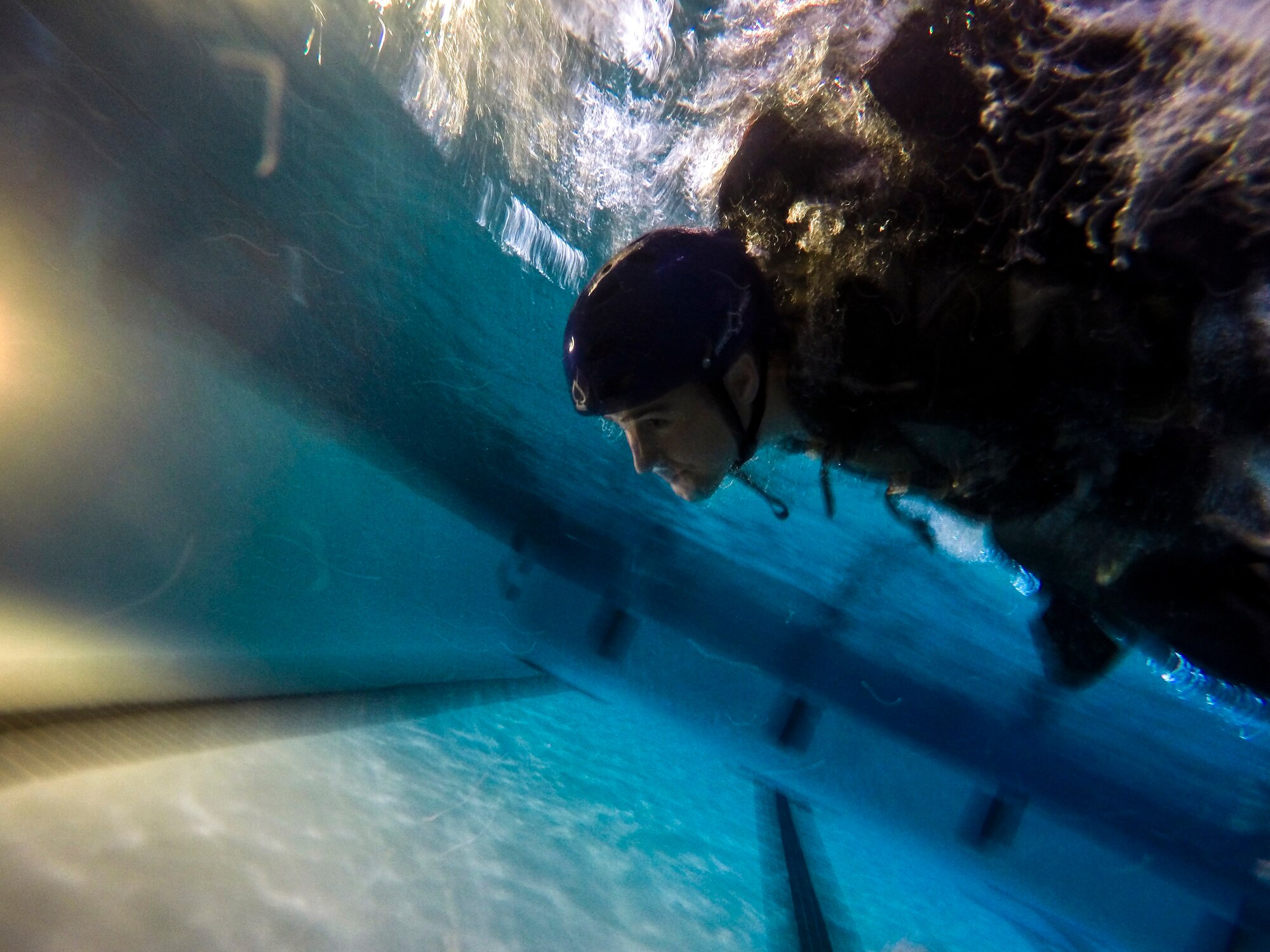 U.S. Air Force Senior Master Sgt. Scott Shier, 71st Rescue Squadron loadmaster, swims during a parachute line scenario during water survival training, Sept. 15, 2016, at Moody Air Force Base, Ga. Survival, Evasion, resistance and escape specialists from the 347th Operations Support Squadron are responsible for familiarizing aircrews with survival equipment and proper techniques to survive in water in the event of ejecting from an aircraft. (U.S. Air Force photo by Airman 1st Class Daniel Snider)