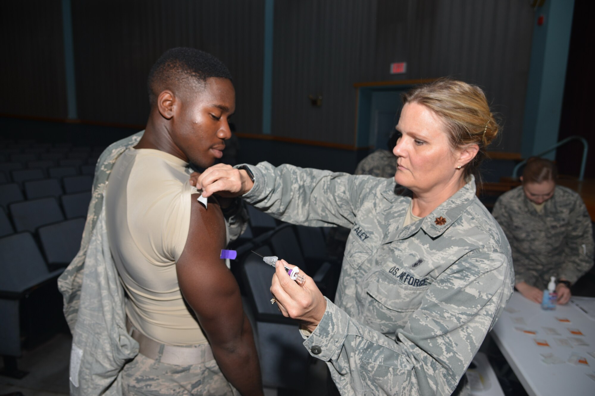Maj. Anne Staley, 377th Medical Group, gives a flu shot at a 2015 clinic. Flu vaccination is mandatory for active-duty members by Dec. 15. (Photo by Todd Berenger)